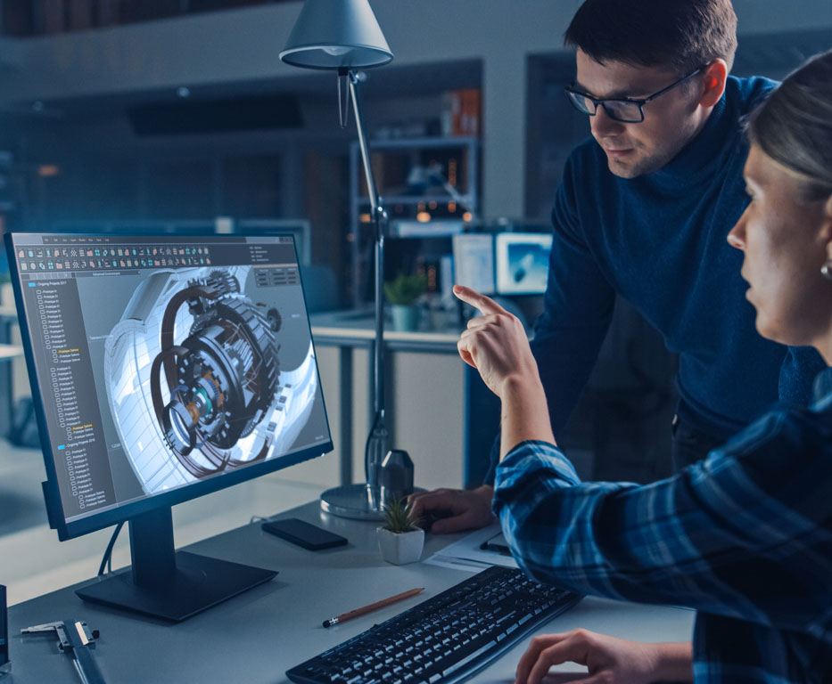 Engineer Working on Desktop Computer, Screen Showing CAD Software with Engine D Model, Her Male Project Manager Explains Job Specifics Industrial Design Engineering Facility Office